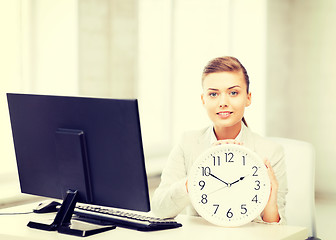 Image showing attractive businesswoman with white clock