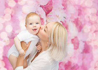 Image showing happy mother kissing smiling baby