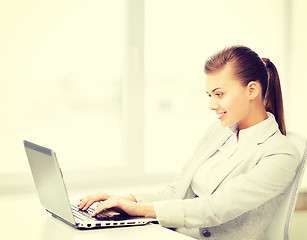 Image showing businesswoman with laptop in office