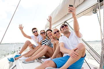 Image showing smiling friends sitting on yacht deck