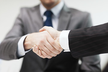 Image showing two businessmen shaking hands in office