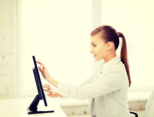 Image showing smiling businesswoman with touchscreen in office