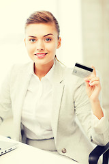 Image showing businesswoman with laptop showing credit card