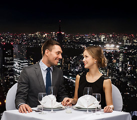 Image showing smiling couple looking at each other at restaurant