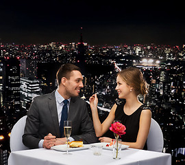 Image showing smiling couple eating dessert at restaurant