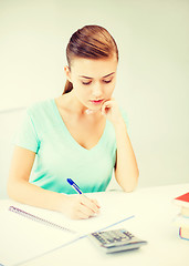 Image showing student girl with notebook and calculator