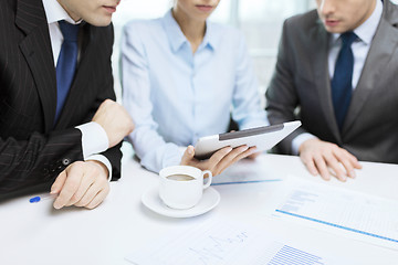 Image showing business team with graph, tablet pc and coffee