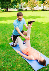 Image showing serious couple stretching outdoors