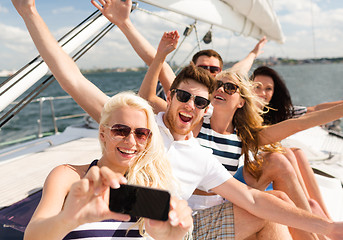 Image showing smiling friends sitting on yacht deck