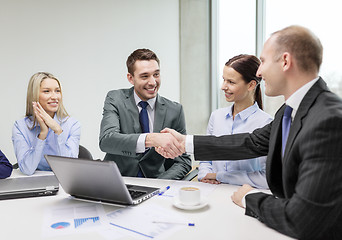 Image showing two businessman shaking hands in office