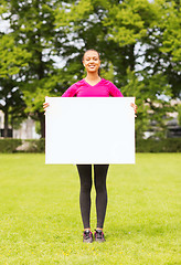 Image showing smiling teenage girl with blank white board