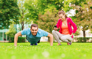 Image showing smiling man doing exercise outdoors