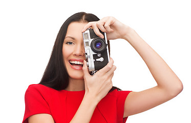 Image showing smiling woman taking picture with digital camera