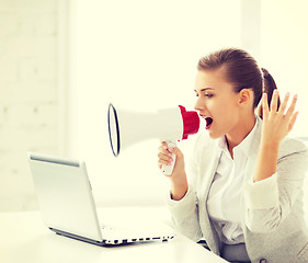 Image showing strict businesswoman shouting in megaphone