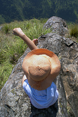 Image showing Woman on top of rock