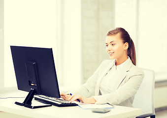 Image showing businesswoman with computer in office