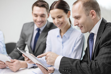 Image showing business team with tablet pc having discussion