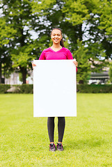 Image showing smiling teenage girl with blank white board