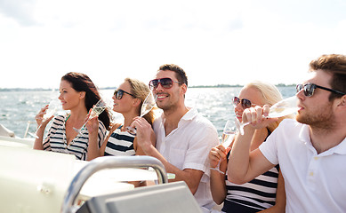 Image showing smiling friends with glasses of champagne on yacht