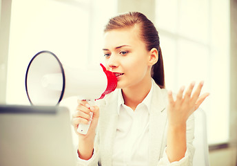 Image showing strict businesswoman shouting in megaphone