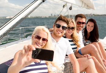 Image showing smiling friends sitting on yacht deck