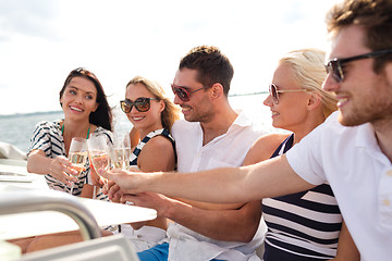 Image showing smiling friends with glasses of champagne on yacht