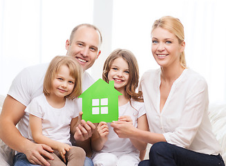 Image showing smiling parents and two little girls at new home