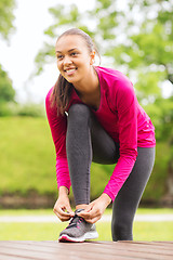 Image showing smiling woman exercising outdoors