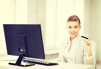 Image showing businesswoman with computer using credit card