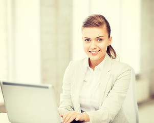 Image showing businesswoman with laptop in office