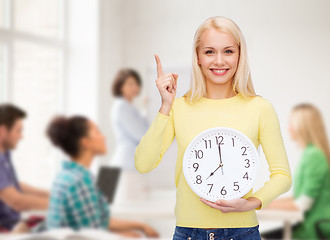 Image showing student with wall clock and finger up