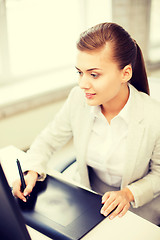 Image showing businesswoman with drawing tablet in office