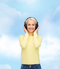 Image showing smiling young woman with headphones