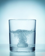 Image showing effervescent dissolving fizzy tablet in water