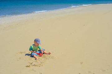 Image showing Little boy playing with sand