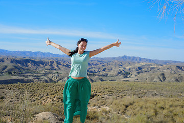 Image showing Happy woman open arms stand at mountain