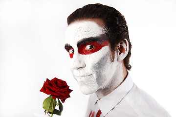 Image showing Man with white mascara and red rose