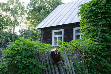 Image showing old country house with windows and fence clay jug 