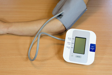 Image showing female patient check measure her blood pressure 