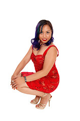 Image showing Crouching Asian woman.