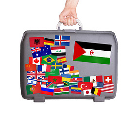 Image showing Used plastic suitcase with stickers