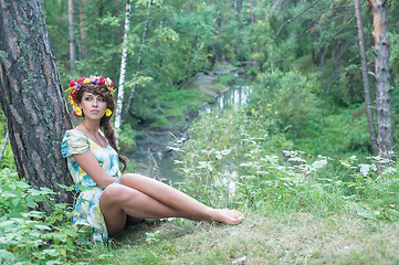 Image showing Beautiful woman with flower wreath near stream