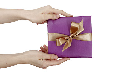 Image showing Young woman holding a present