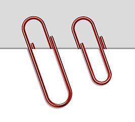Image showing Red metal paperclip and paper