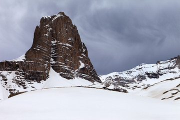 Image showing Snowy rocks and grey sky