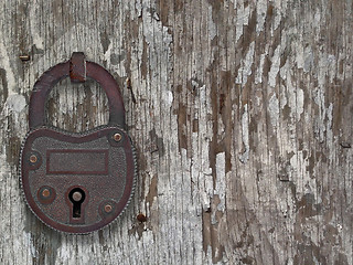 Image showing vintage padlock on a old door