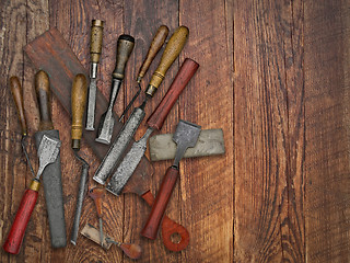 Image showing vintage chisels and stones collage over old wooden bench