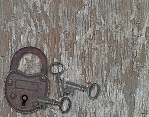 Image showing vintage padlock on a old wooden panel