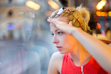 Image showing Woman looking out tram's window.