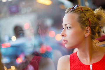 Image showing Woman looking out tram's window.